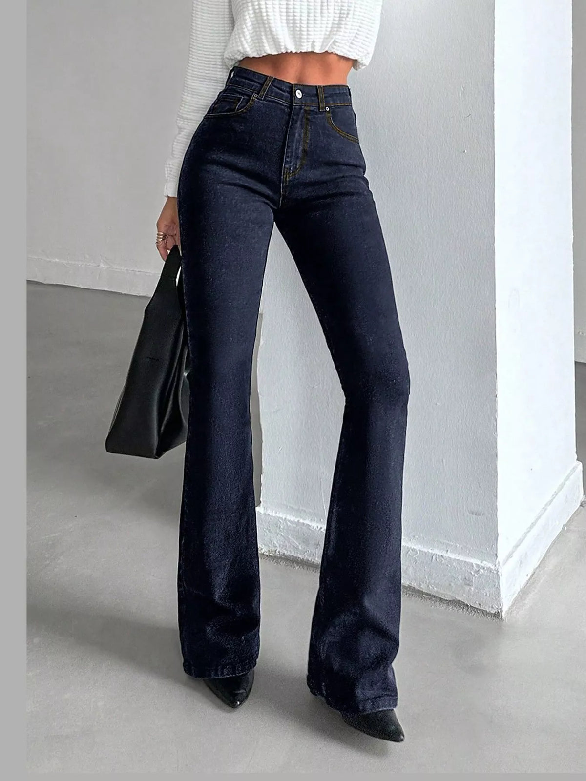 Vera High-Waisted Slim Flare Jeans in Black, on model
