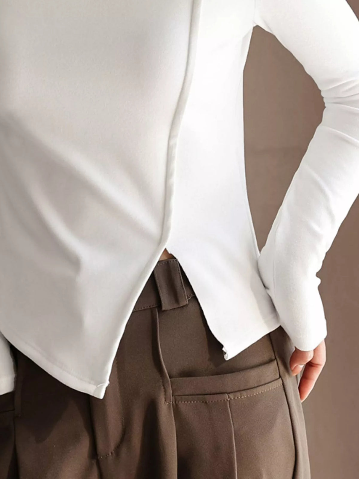 Una Asymmetric Mock-Neck Long-Sleeve Top in White, on model