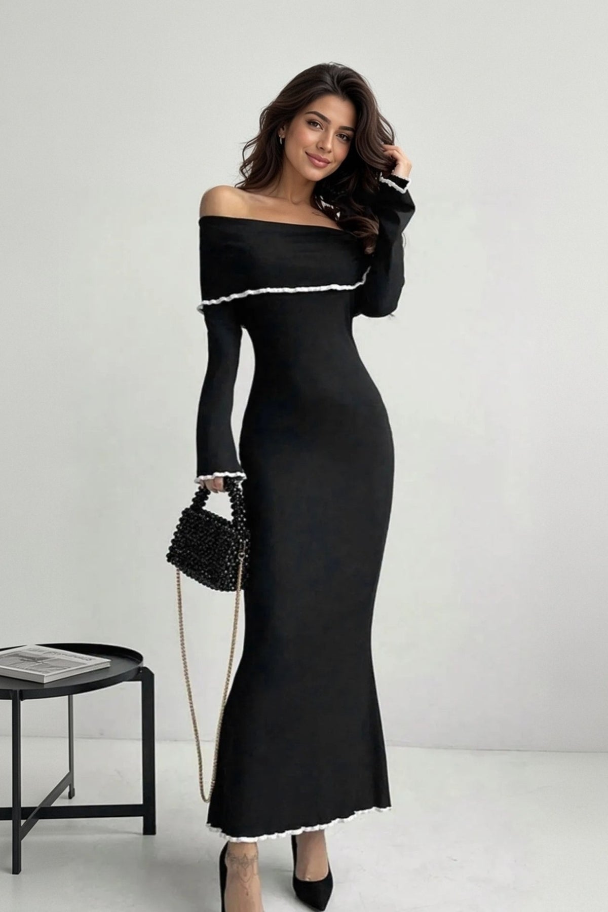 Noemi black off-shoulder maxi sweater dress with white contrast trim, on model, front view